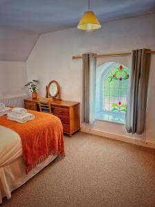 a bedroom with a bed and a stained glass window at The Old Chapel in Axminster