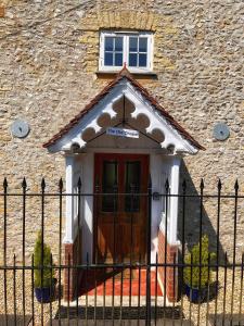 a building with a door with a sign on it at The Old Chapel in Axminster