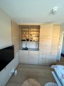 a kitchen with white cabinets and a sink at Studio Leiligheit in Sogndal