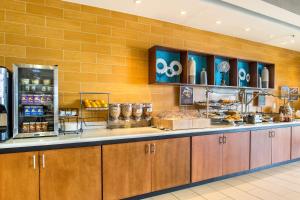 a buffet line in a restaurant with food at SpringHill Suites by Marriott Houston Rosenberg in Rosenberg