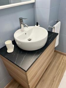 a white sink on a counter in a bathroom at Stadiumapartament in Santa Cruz de Tenerife