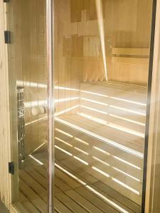 a shower with a glass door in a room at Panorama Kvariati beach in Kvariati
