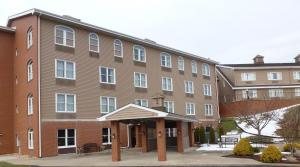 a large brick building with white windows at Inn at Mountainview in Greensburg