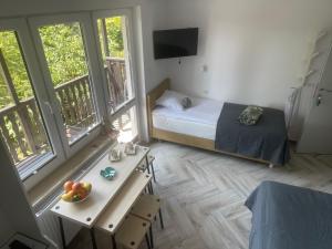 a bedroom with a bed and a table with fruit on it at Dziupla Dębki in Dębki