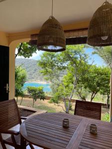 a dining room table with chairs and a large window at Apartment Monte Rosa in Mali Lošinj +6 photos
