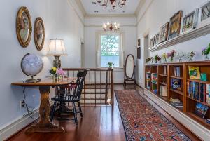 a living room with a table and bookshelves at Stonegate in Lexington