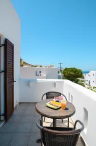 a small table and chairs on a balcony at Villa Andromeda in Amorgos