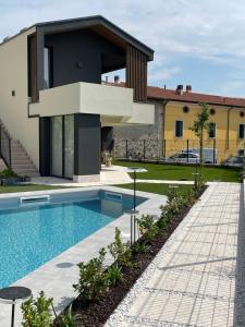 a villa with a swimming pool and a house at Villa San Zeno Rooms in Bardolino