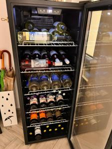 a refrigerator filled with lots of bottles of beer at Dziupla Dębki in Dębki