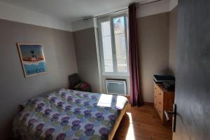 una camera da letto con un letto e una finestra di Appartement T2, 1 seule chambre, très lumineux a Bandol