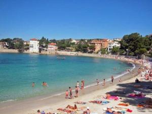 un gruppo di persone su una spiaggia in acqua di Appartement T2, 1 seule chambre, très lumineux a Bandol