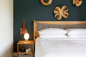 a bedroom with a white bed and a green wall at Bode Nashville in Nashville +35 photos
