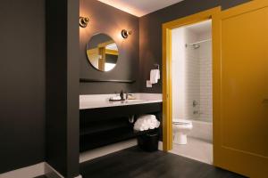 a bathroom with a sink and a mirror at Bode Nashville in Nashville +46 photos