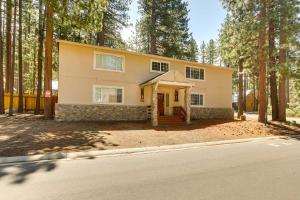 a house in the middle of a forest at Homey South Lake Tahoe Getaway - 1 Mi to Beach in South Lake Tahoe