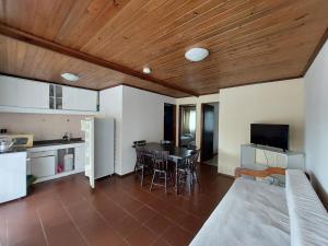 a living room with a kitchen and a dining room at Hotel Jardines de Dayman in Termas del Daymán