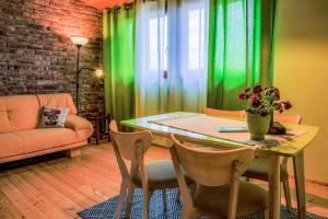 a dining room with a table and green curtains at Kowalowe Skały SPA&MORE in Jelenia Góra