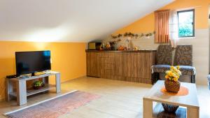 a living room with a flat screen tv and a table at Nature View Cozy Flat 1 min to Sea in Kotor in Tivat