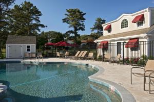 a swimming pool in front of a house at Wellfleet Lodge in Wellfleet