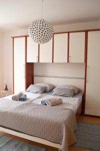 a bedroom with a large bed with two pillows at Apartment SeaShell in Jadranovo