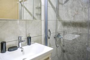 a bathroom with a shower and a sink and a shower at Just Dream Suites in Kaş