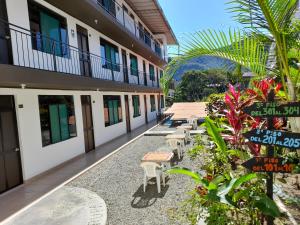 a courtyard of a building with tables and chairs at Hotel Rupa Rupa in San Ramón