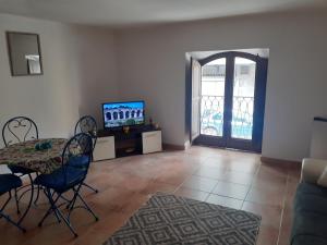 een woonkamer met een tafel en een televisie bij Sicilia bedda in Palermo