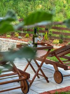 a picnic table with two glasses of wine on it at Kuća za odmor Zora 