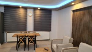 a meeting room with a table and chairs and blinds at Peri suit evleri in Tunceli