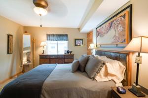 a bedroom with a large bed and a painting on the wall at Waterfront Johnson Lake Getaway with Kayaks and Grill! 