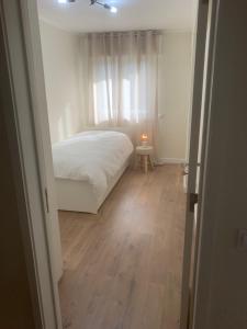 una piccola camera da letto con un letto e una finestra di Cantinho de Benfica ad Amadora