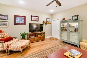 a living room with a tv and a couch at Charming Starkville Vacation Rental about 5 Mi to MSU! in Starkville