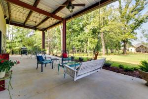 a covered patio with chairs and a table at Charming Starkville Vacation Rental about 5 Mi to MSU! in Starkville
