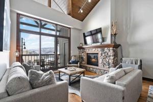 a living room with a couch and a fireplace at Borders Lodge by East West Hospitality in Beaver Creek