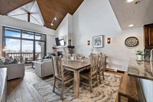 a kitchen and living room with a table and chairs at Borders Lodge by East West Hospitality in Beaver Creek