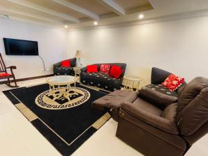 a living room with two couches and a tv at Misty Mountain in Murree