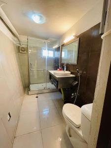 a bathroom with a toilet and a sink and a shower at Misty Mountain in Murree