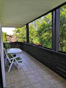 a balcony with a table and chairs on it at Ferienwohnungen Schelhas in Prien am Chiemsee +6 photos