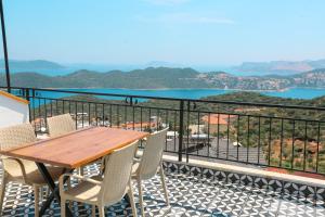 a table and chairs on a balcony with a view at Just Dream Suites in Kaş