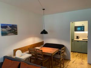 a kitchen and dining room with a table and chairs at Mölltaler Gletscher Apartment in Flattach