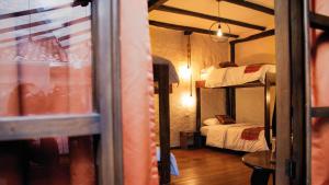 a room with two bunk beds and a window at Hostal Restaurant La Cigale in Cuenca