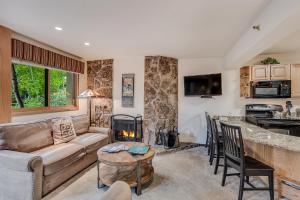 a living room with a couch and a fireplace at Laurelwood Condominiums 307 in Snowmass Village