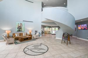 a living room with a couch and a staircase at Beachfront Retreat- "The Getaway" in Destin