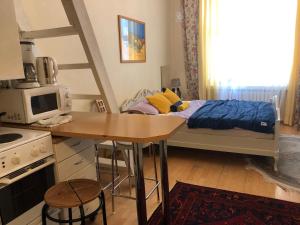 una piccola cucina con un letto e un tavolo in una stanza di Sharm Sweet Studio City Center Kamppi 49 Kalevankatu a Helsinki