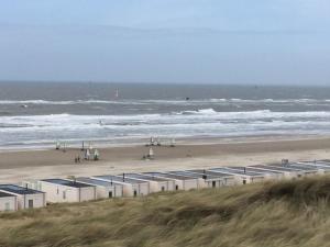 a beach with a bunch of buildings and the ocean at Almost At The Beach in Wijk aan Zee