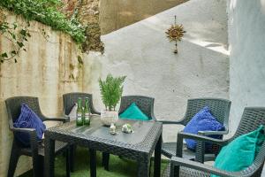 a table and chairs on a patio with blue pillows at Stylish 2 BR in Clifton - Garden in Bristol