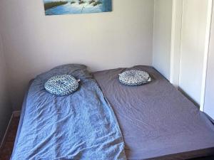 a bed with two pillows on it in a room at 6 person holiday home in SANDHULT-By Traum in Sandhult