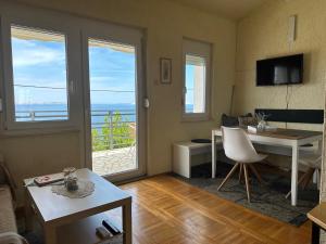 a living room with a view of the ocean at Prizna Apartments in Prizna