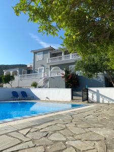 a villa with a swimming pool and a house at Villa Karras in Pythagoreio