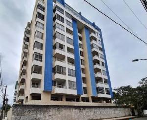 a tall building with blue columns on top of it at Luxuoso a 250 Mts da Praia in Guarapari