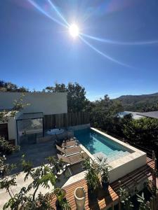 una piscina con tumbonas y luz del sol en Statera Host, en Alto Paraíso de Goiás